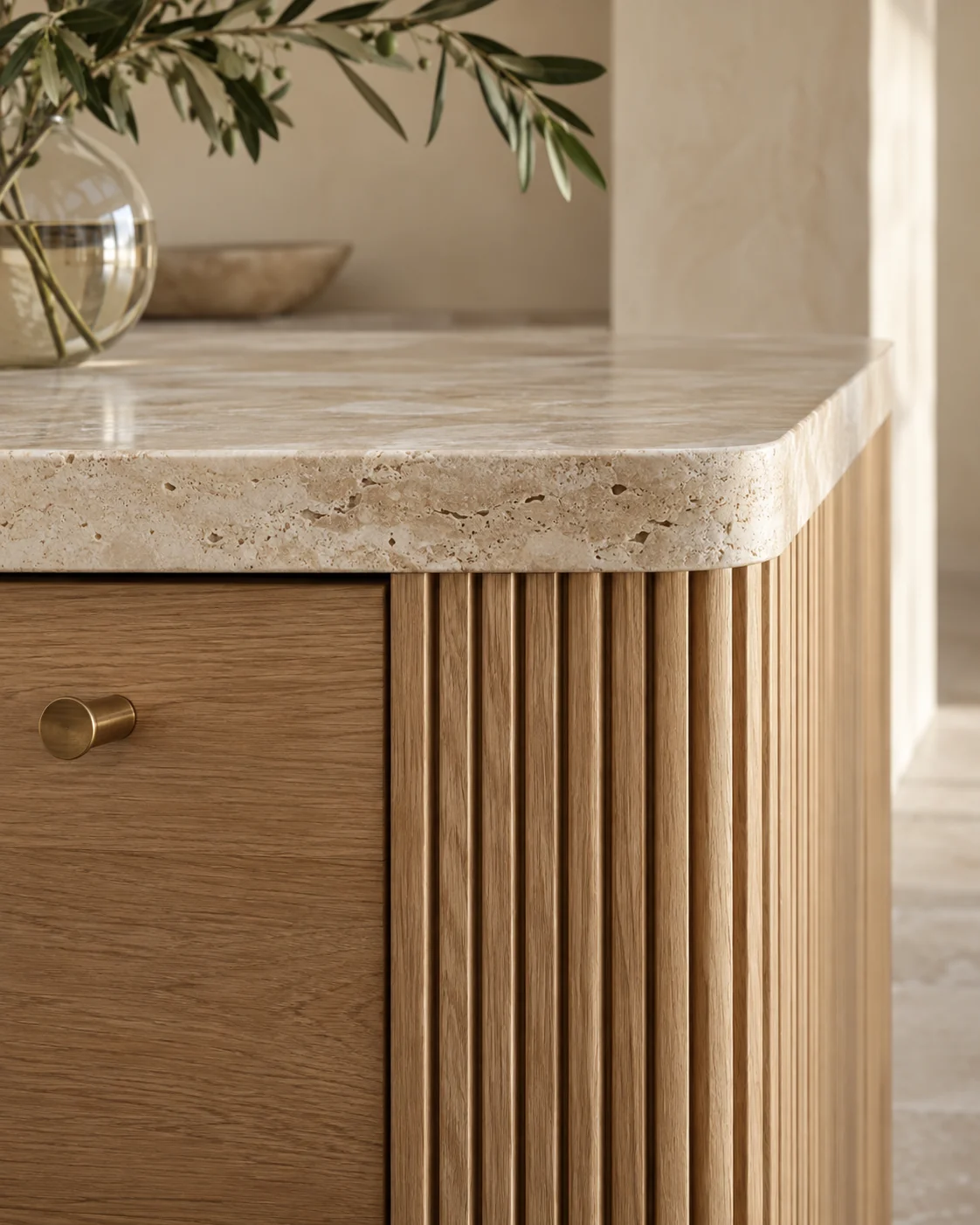 AI design detail showing fluted oak cabinetry, a rounded travertine edge and a brushed brass handle